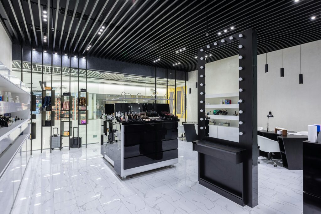 Highly stylized contemporary makeup store with elegant furnishings and lighting.